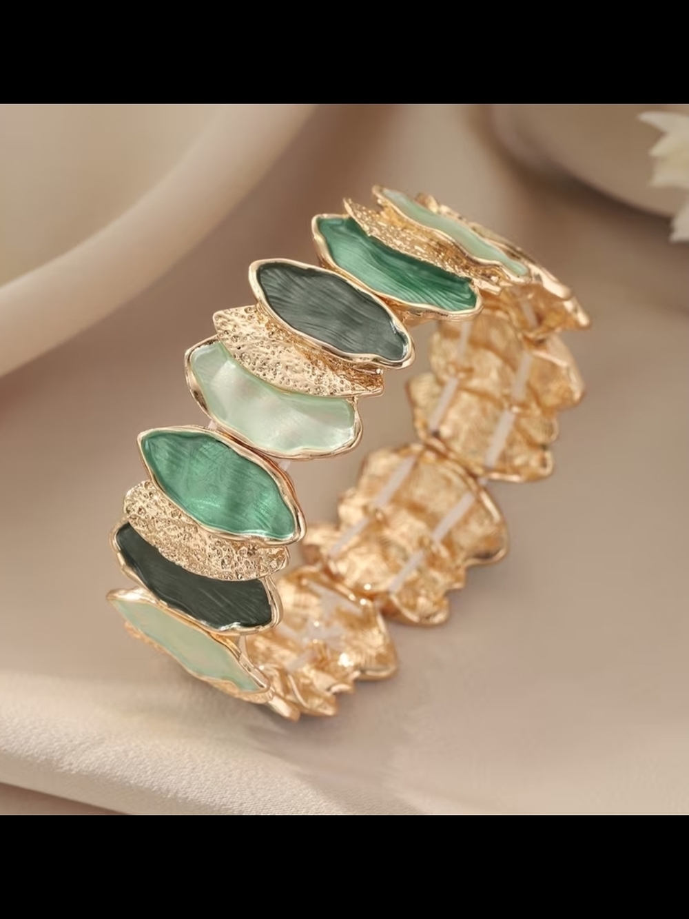 Strerchy Gold-Tone Stretch Bracelet with Green Enamel Leaf Accents. No Tarnish